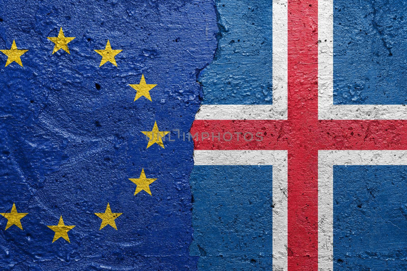 European Union and Iceland - Cracked concrete wall painted with a EU flag on the left and a Icelandic flag on the right stock photo by adamr