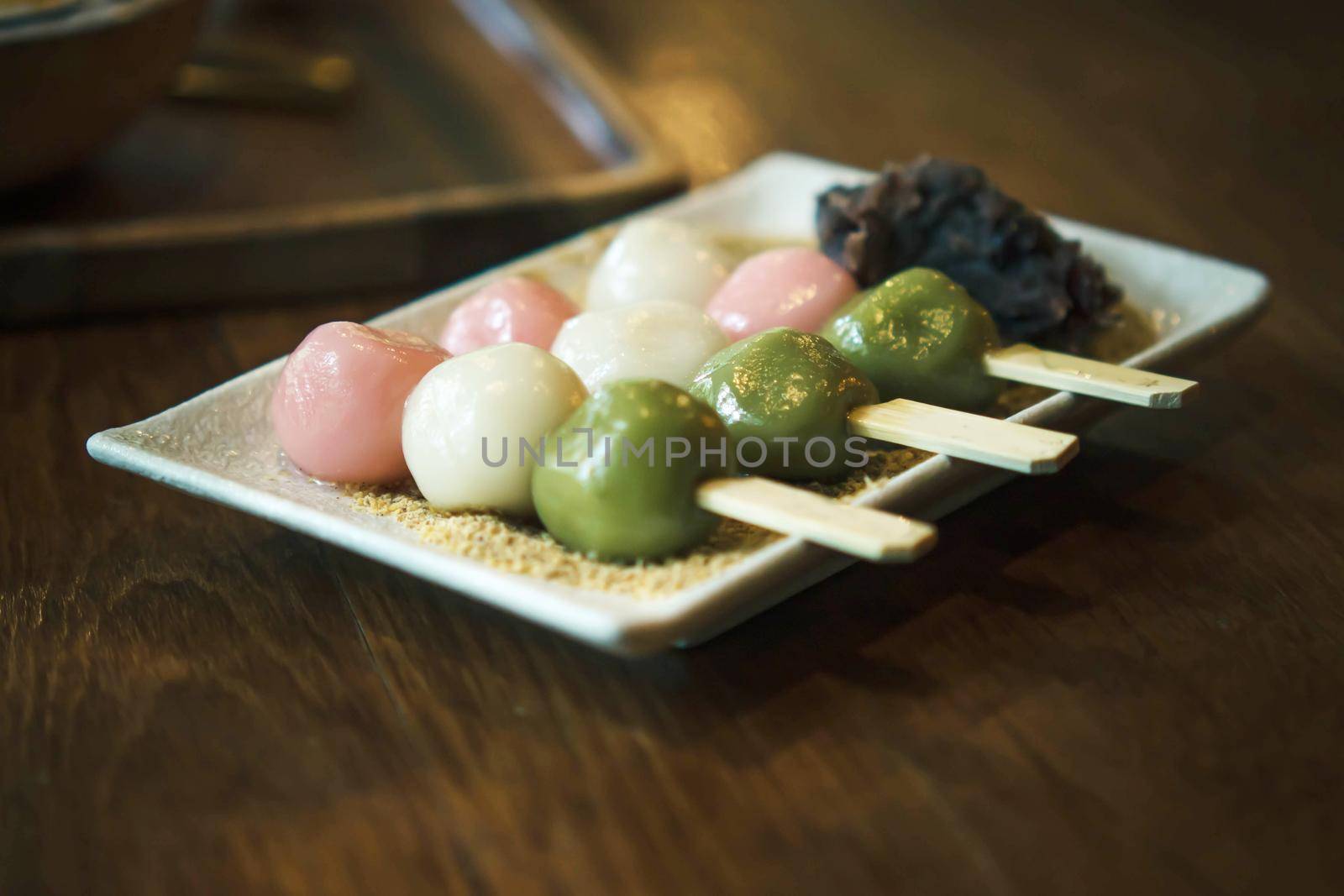 Three Color Japanese  Hanami Dango Dumpling sweet dessert on white ceramic plate.