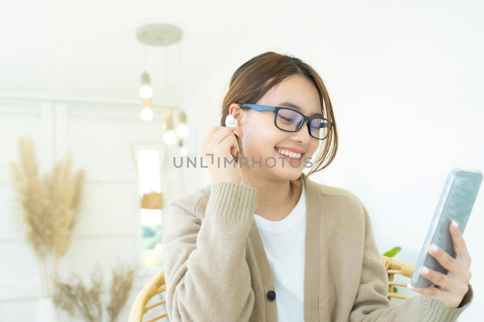 Close up of woman using mobile phone, Video call using headphones.