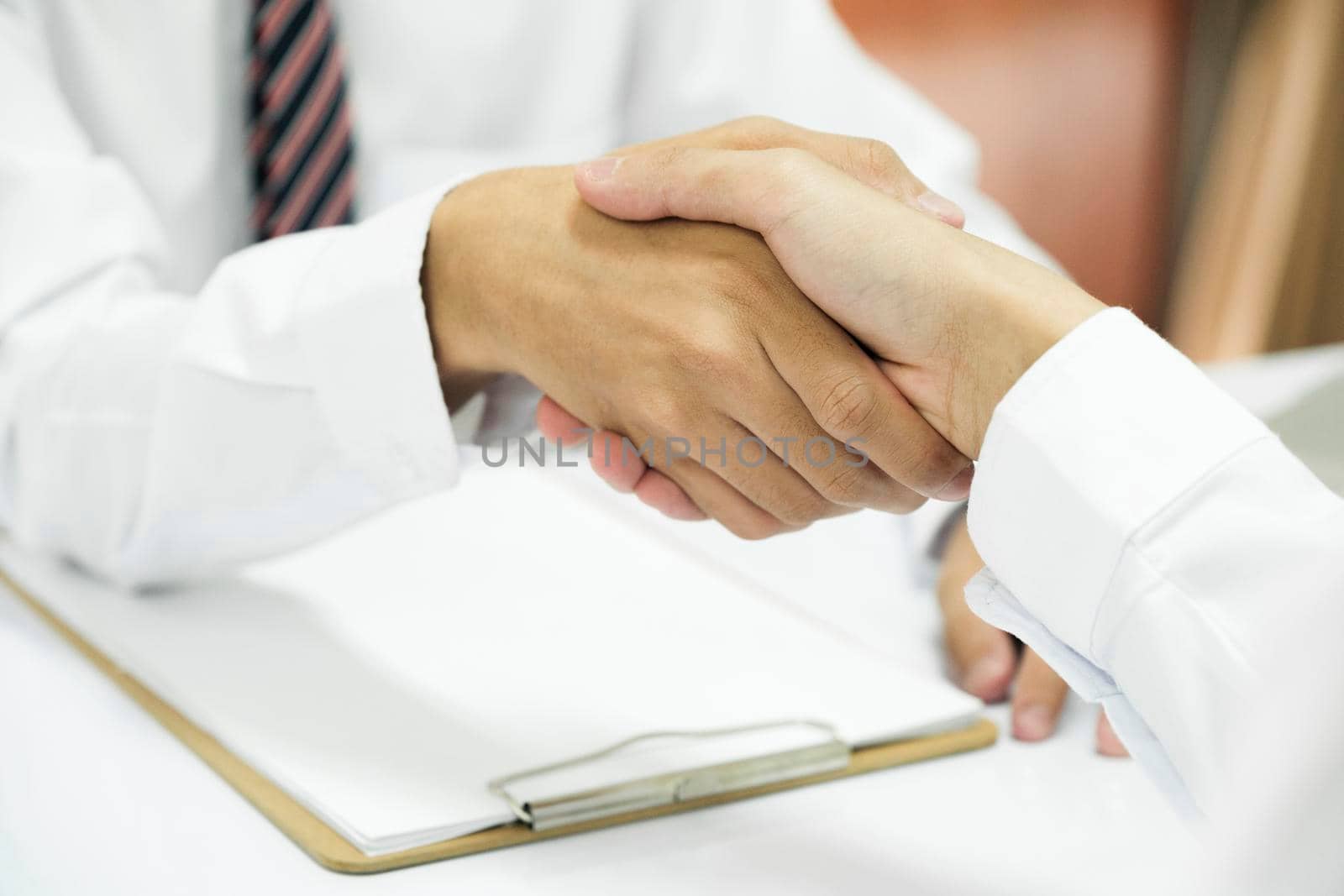 Businessman Shaking hands with Professional male lawyer after discussing good deal of contract in courtroom, Concepts of law, Legal services advice at the law office.
