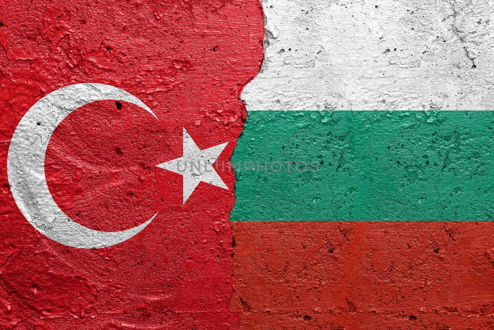 Turkey and Bulgaria - Cracked concrete wall painted with a Turkish flag on the left and a Bulgarian flag on the right stock photo by adamr