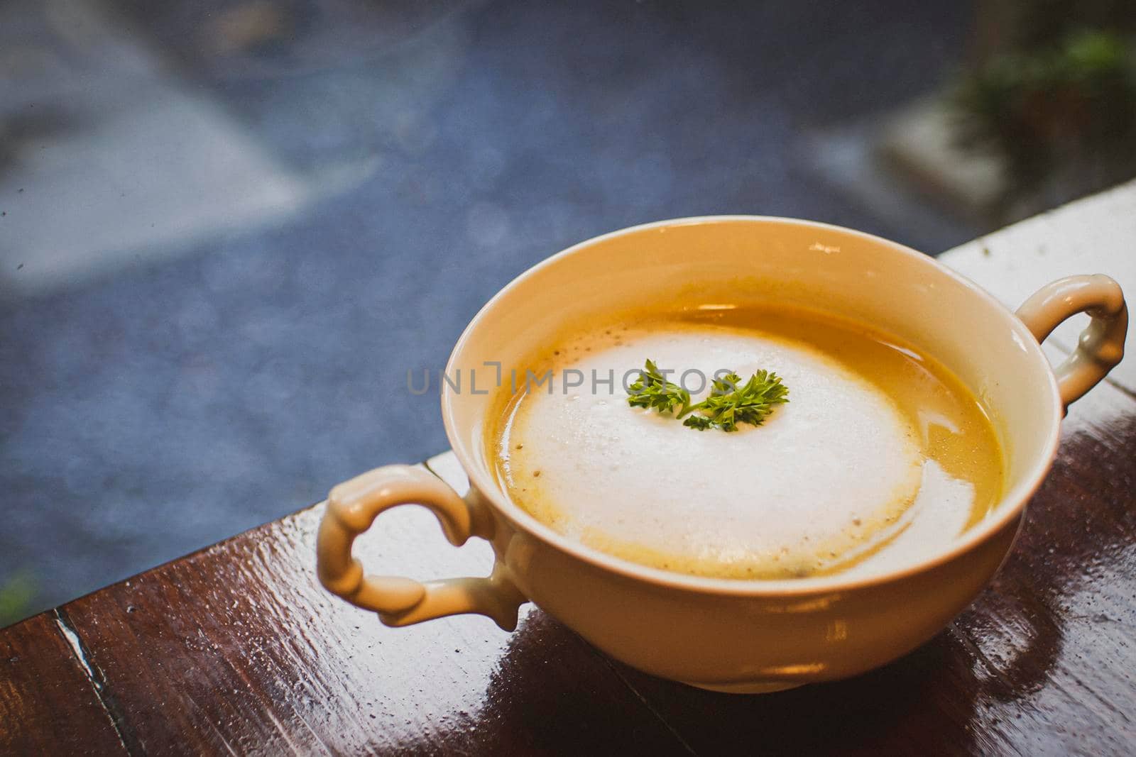 Mushroom Soup in ceramic bowl breakfast meal healthy on the wooden table with blur background.