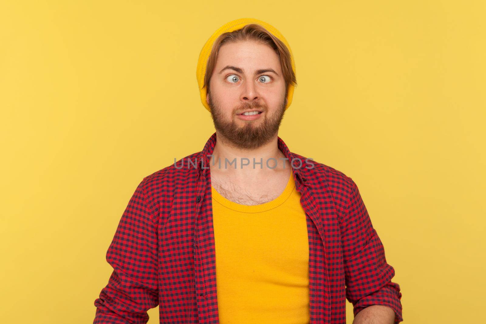 Portrait of emotional hipster man on yellow background. by Khosro1