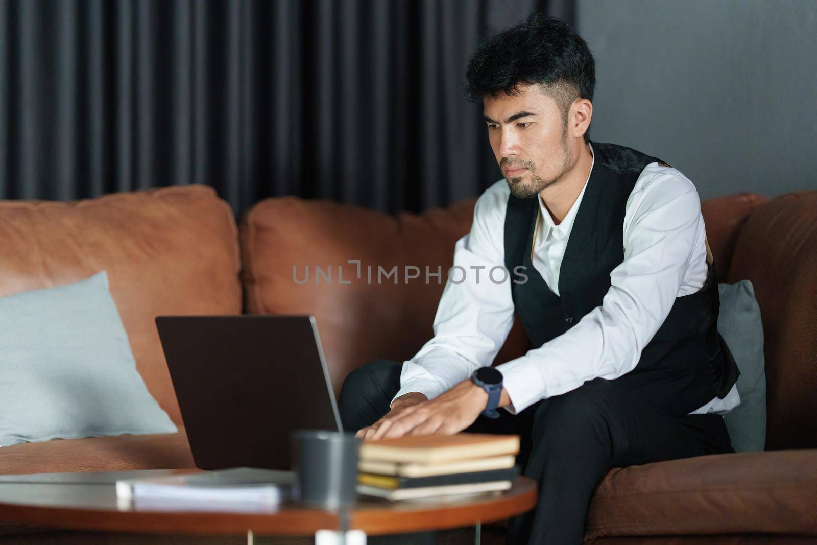 Portrait of Asian Businessman checking schedule and waiting for meet customer
