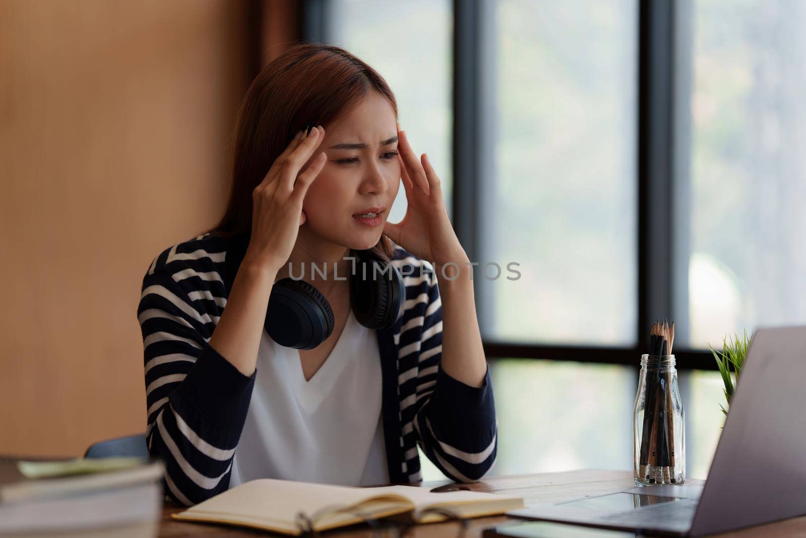 Image of Asian Business woman stressed after end of video conference at home. Expression and Emotional concept