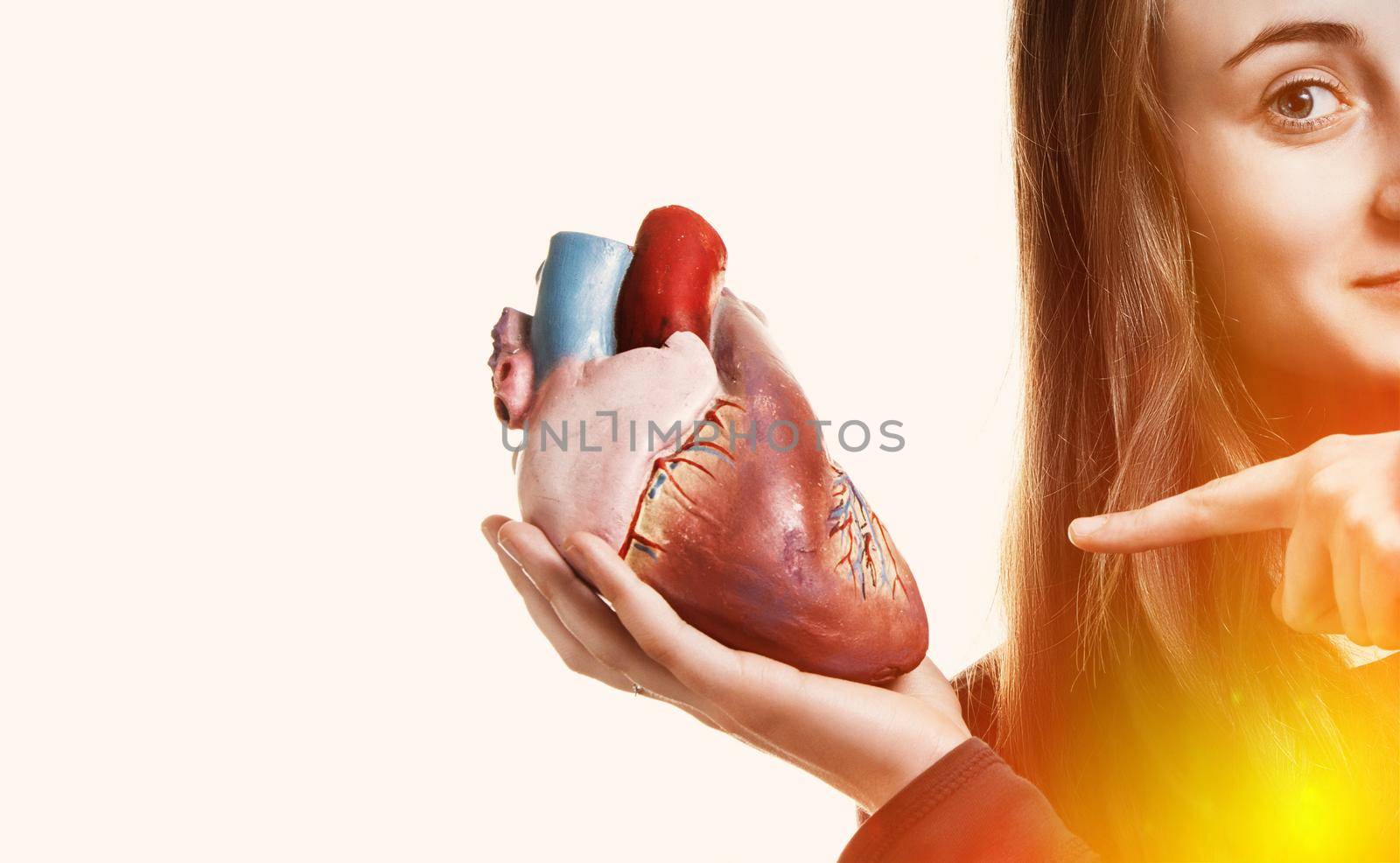 Young woman with heart in hand. Abstract creative background. With copy-space