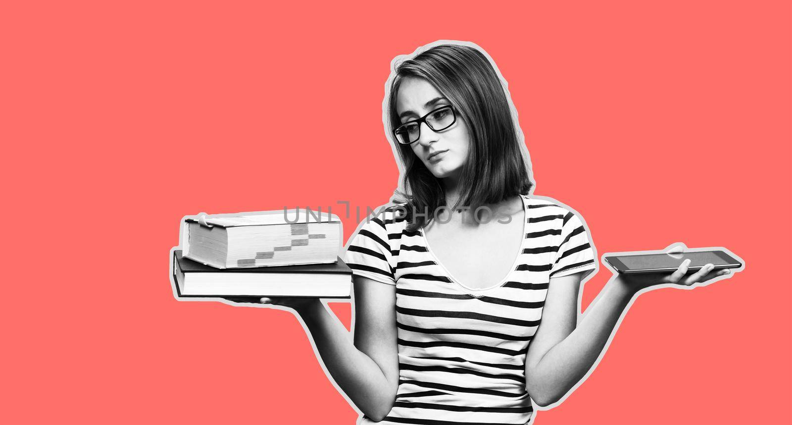 Contemporary education concept. Book vs e-book. Girl student holding traditional textbook and ebook reader on background with copy space. Black and White image on trend living coral color background.