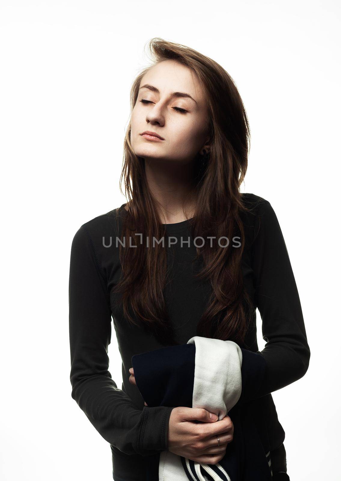 Happy teenage girl. Fashion, portrait and people concept. Portrait of a young emotional and stylish woman on a light background in the studio