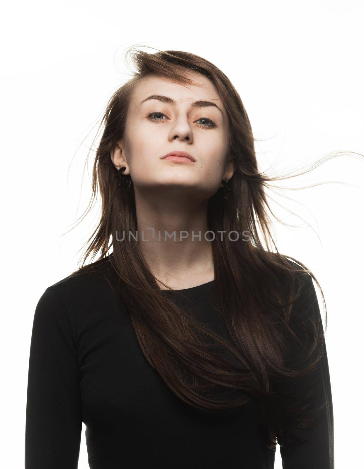 Happy teenage girl. Fashion, portrait and people concept. Portrait of a young emotional and stylish woman on a light background in the studio
