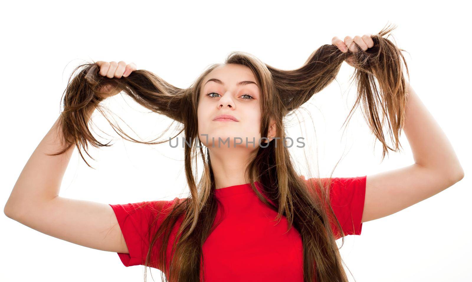 Young woman playing with her ​​hair on white background