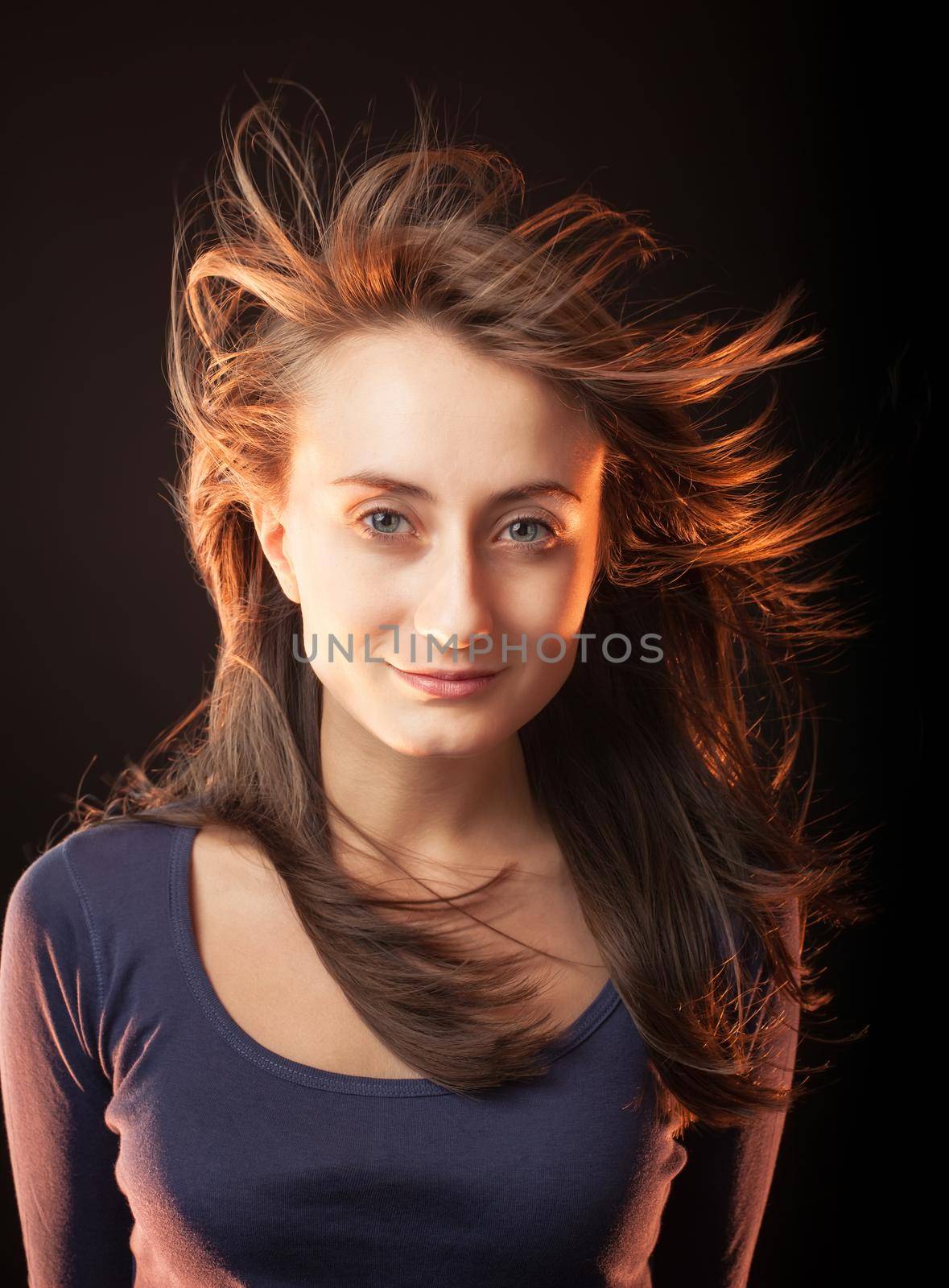 Portrait of a beautiful young woman on a dark background