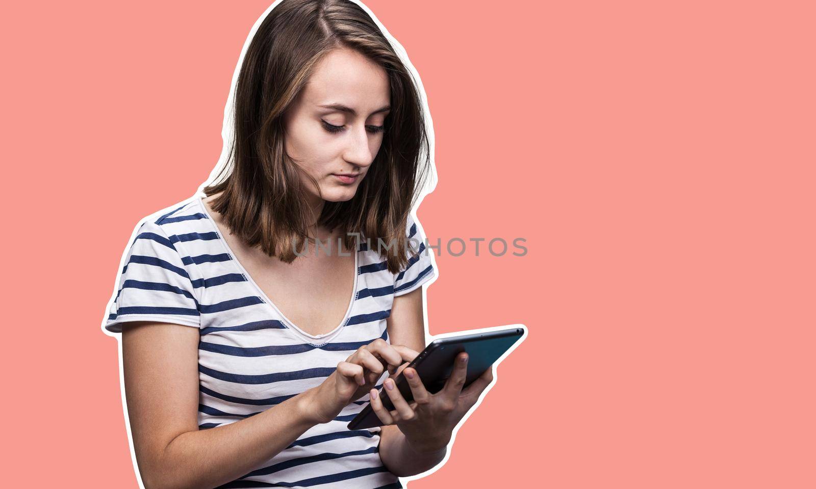 Education and lifestyle concept. Young woman using a digital tablet. Modern gadget in hand. Magazine style collage with copy space and trendy coral color background