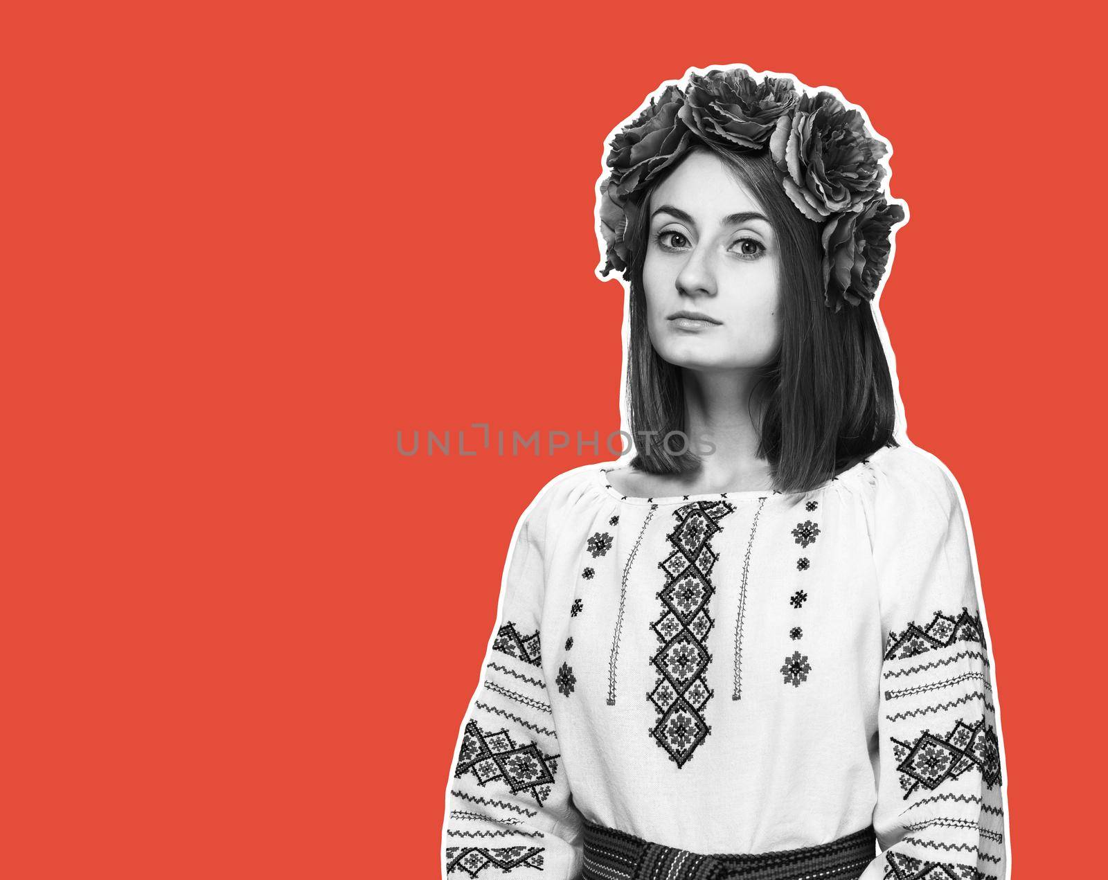 Beautiful sad girl in the Ukrainian national suit. Magazine style collage on trendy coral  background with copy space