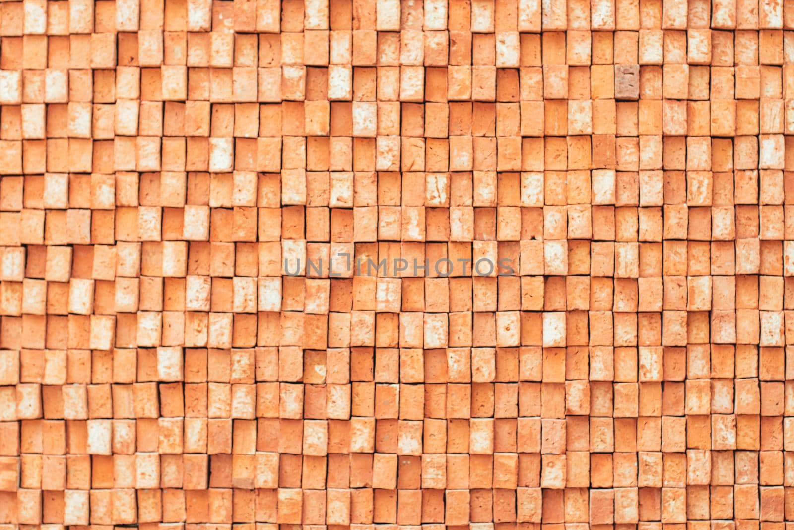 Rectangular orange bricks random pattern wall facade texture material in architecture exterior and interior.