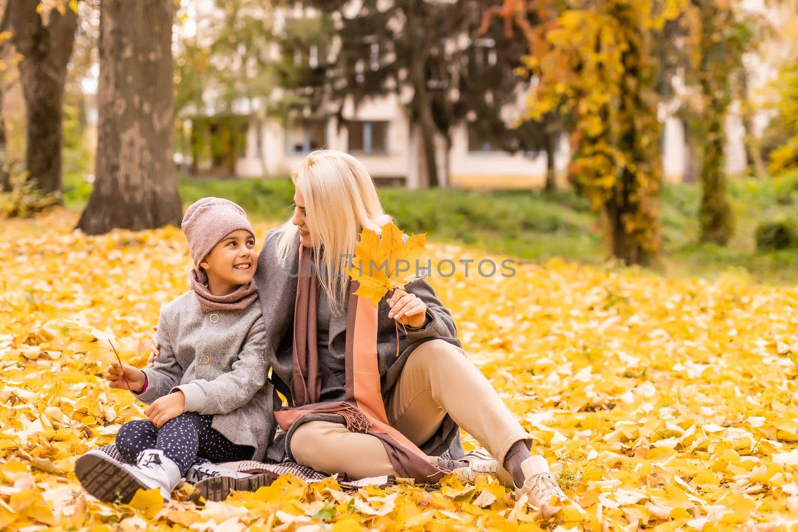 Mother and daughter in autumn yellow park. by Andelov13