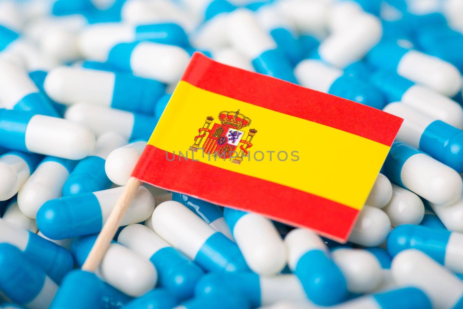 Flag of Spain on blue and white pills