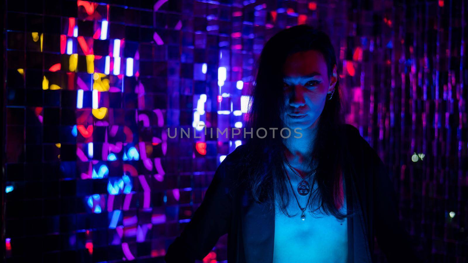 Portrait of a transgender model with a naked torso in a studio with neon lighting. by mrwed54