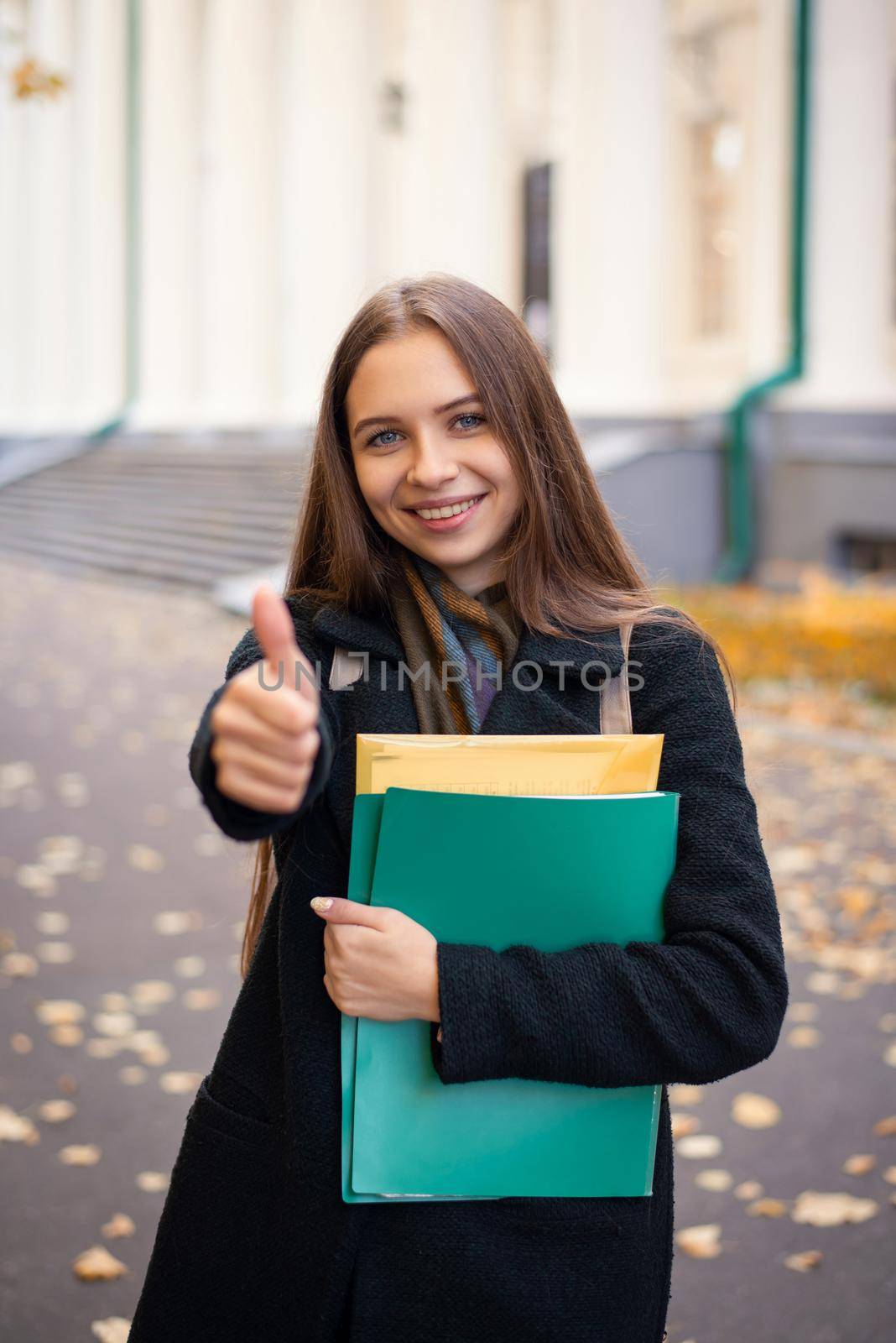 Happy senior student in university campus going to classes