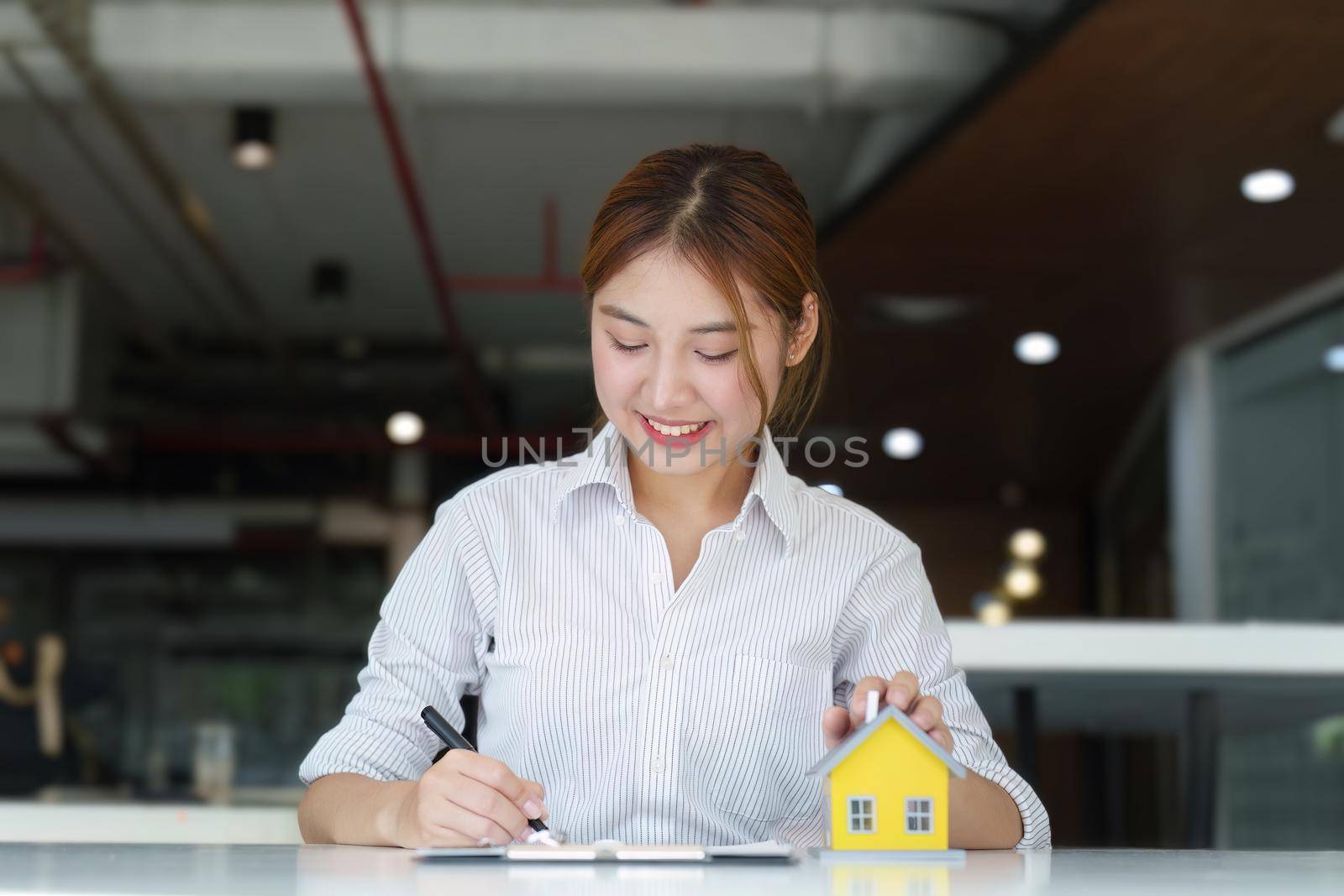 Guarantee, Mortgage, agreement, contract, Signing, Male client holding pen to reading agreement document to sign land loan with real estate agent or bank officer