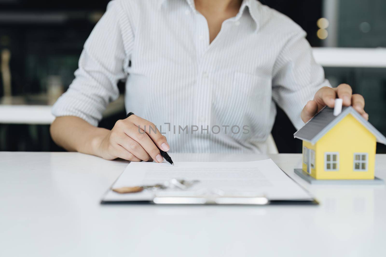 Guarantee, Mortgage, agreement, contract, Signing, Male client holding pen to reading agreement document to sign land loan with real estate agent or bank officer