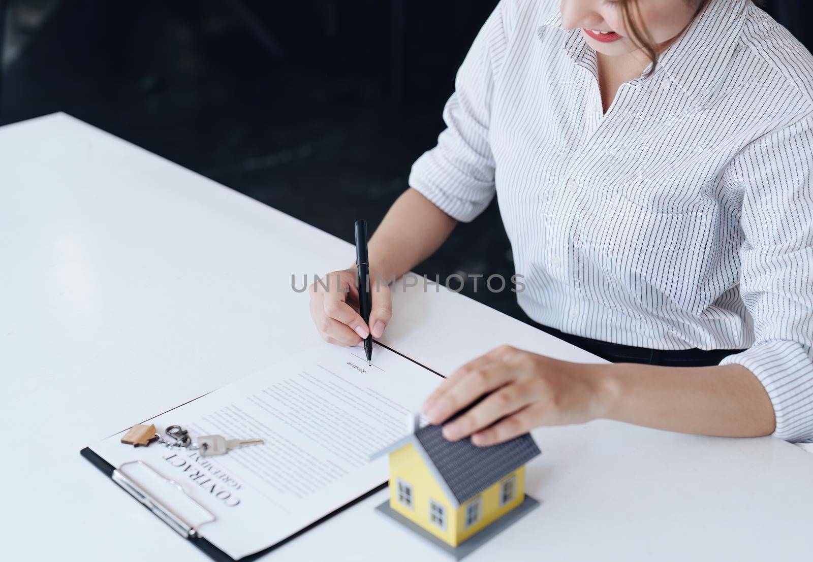 Guarantee, Mortgage, agreement, contract, Signing, Male client holding pen to reading agreement document to sign land loan with real estate agent or bank officer. by Manastrong
