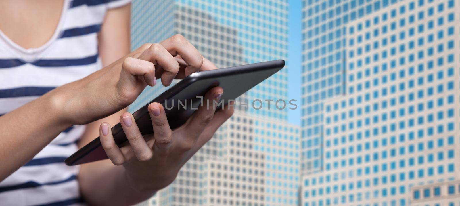 Online Booking in New York City. Hotel reservation via Internet. Young woman uses a tablet PC for hotel reservation against Manhattan background