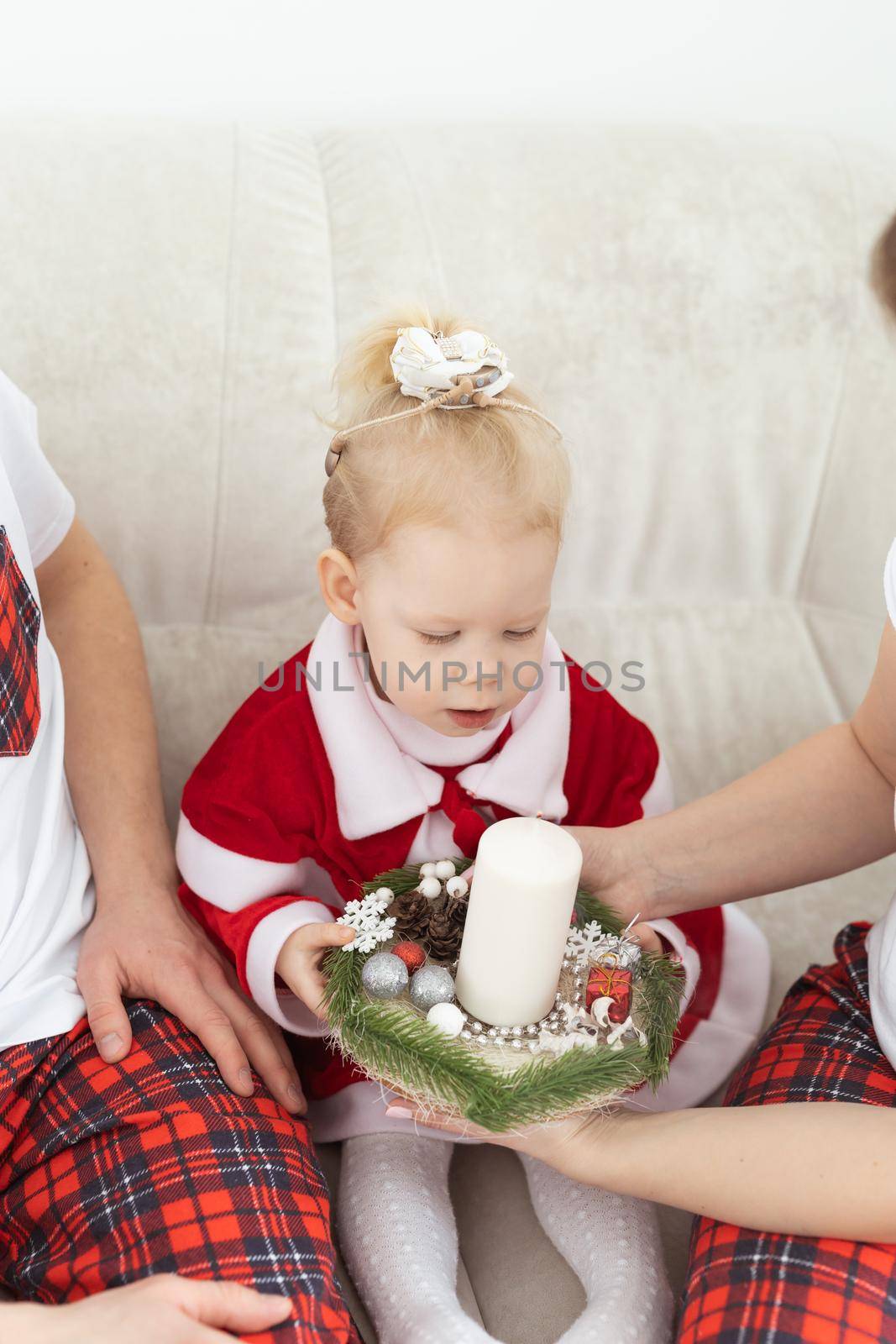 Baby child with hearing aid and cochlear implant having fun with parents in christmas room. Deaf , diversity and health concept by Satura86