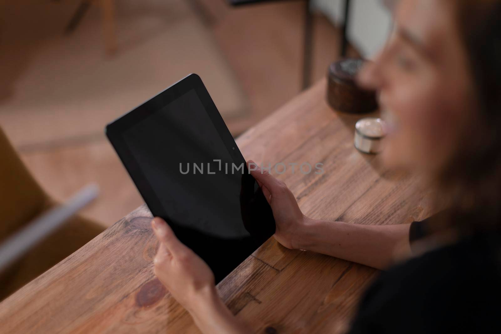 A therapist uses her tablet to manage appointments in the office