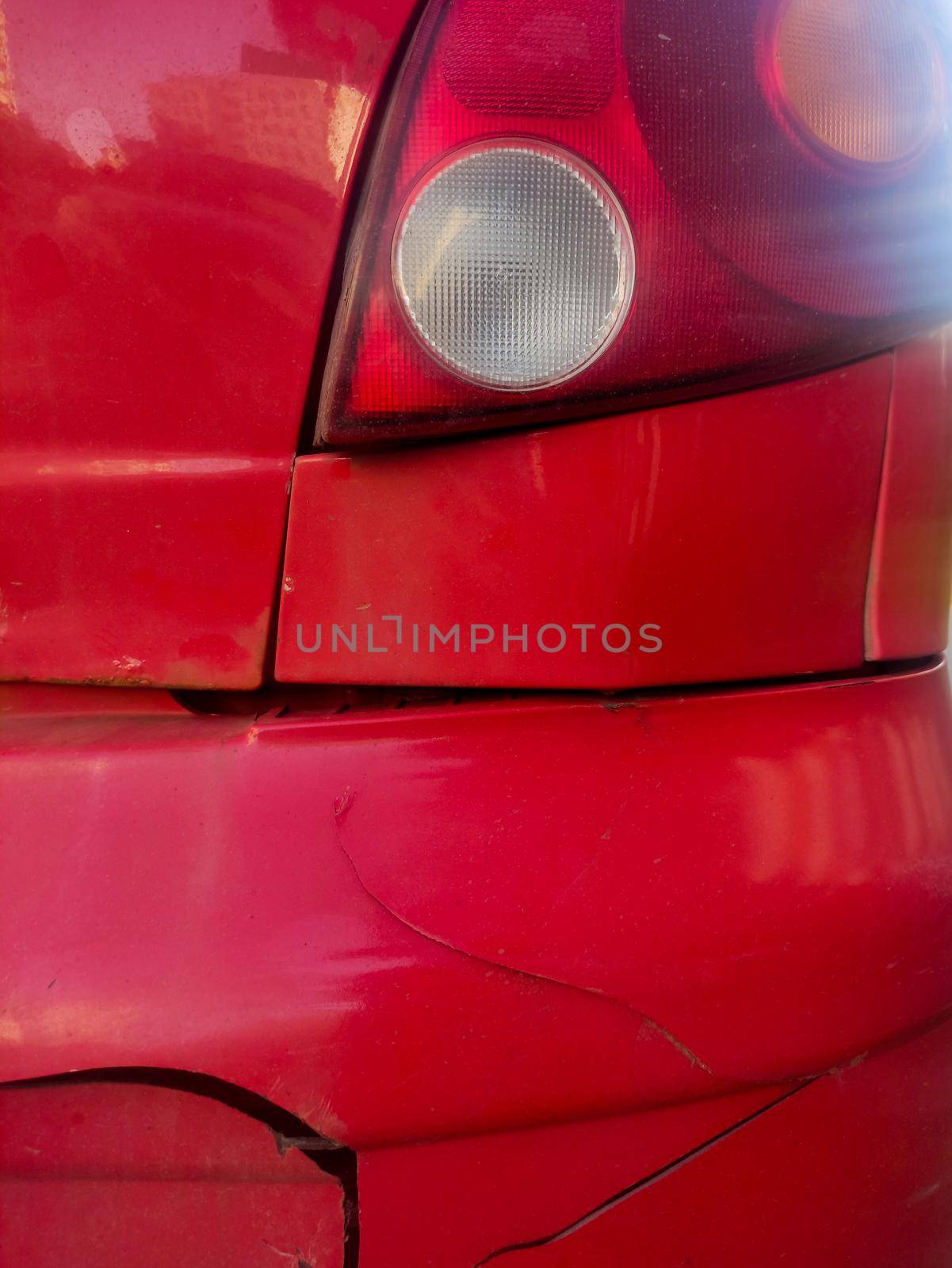 Red broken car detail. Damaged old car close up. High quality photo
