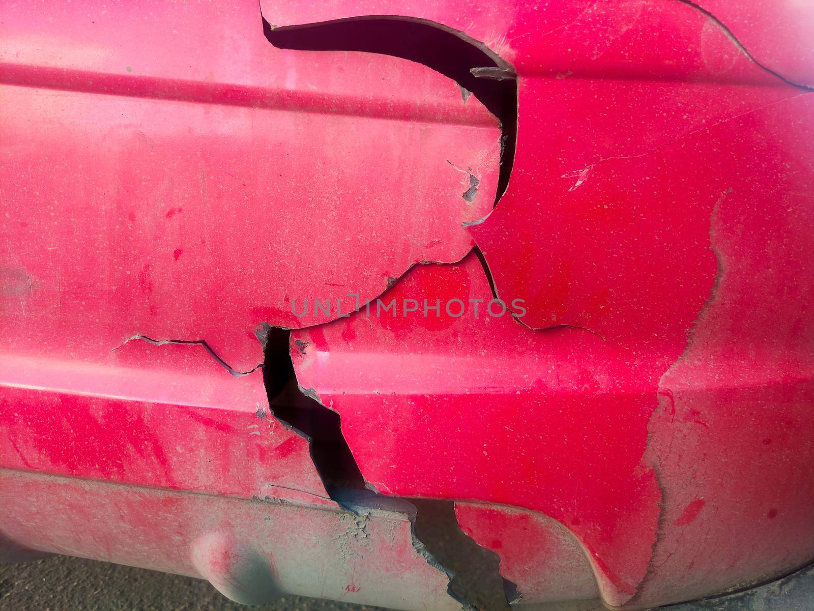 Red broken car detail. Damaged old car close up. High quality photo