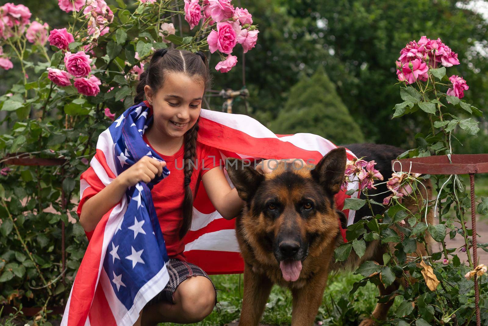 Happy adorable little girl smiling and waving American flag outside, her dress with strip and stars, cowboy hat. Smiling child celebrating 4th july - Independence Day. High quality photo