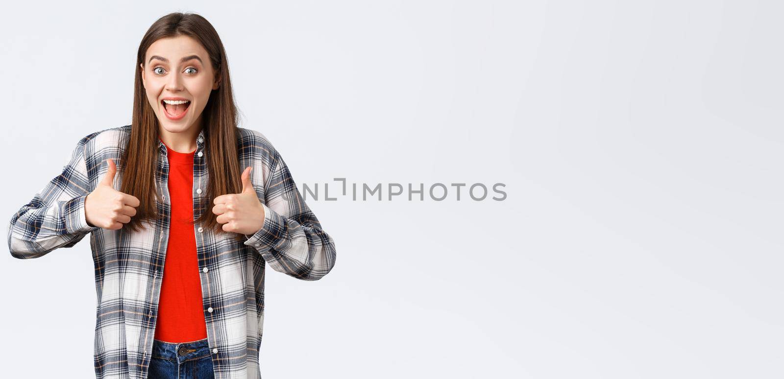 Lifestyle, different emotions, leisure activities concept. Super good idea. Cheerful excited pretty woman in casual checked shirt, thumbs-up and smiling, approving, like idea or support your choice.