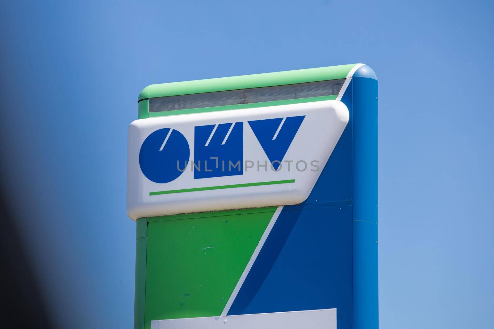 Lazarevac, Serbia - June 20, 2022: Logo and sign of OMV on gas station. OMV is a Hungarian-owned oil company operating in Serbia