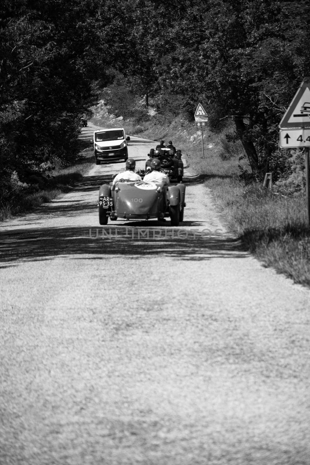 URBINO, ITALY - JUN 16 - 2022 : URBINO, ITALY - JUN 16 - 2022 : ASTON MARTIN 2 LITRE SPEED MODEL 1937 on an old racing car in rally Mille Miglia 2022 the famous italian historical race (1927-1957