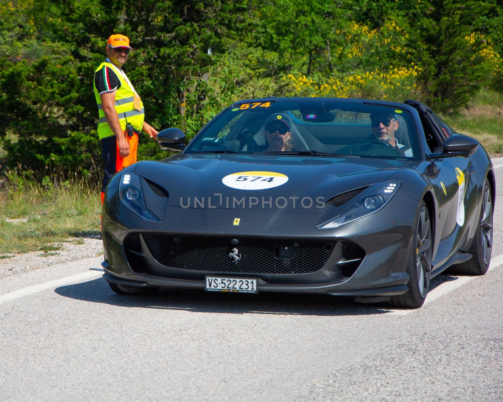 URBINO, ITALY - JUN 16 - 2022 : FERRARI TRIBUTE Ferrari F8 Tributo IN an old racing car in rally Mille Miglia 2022