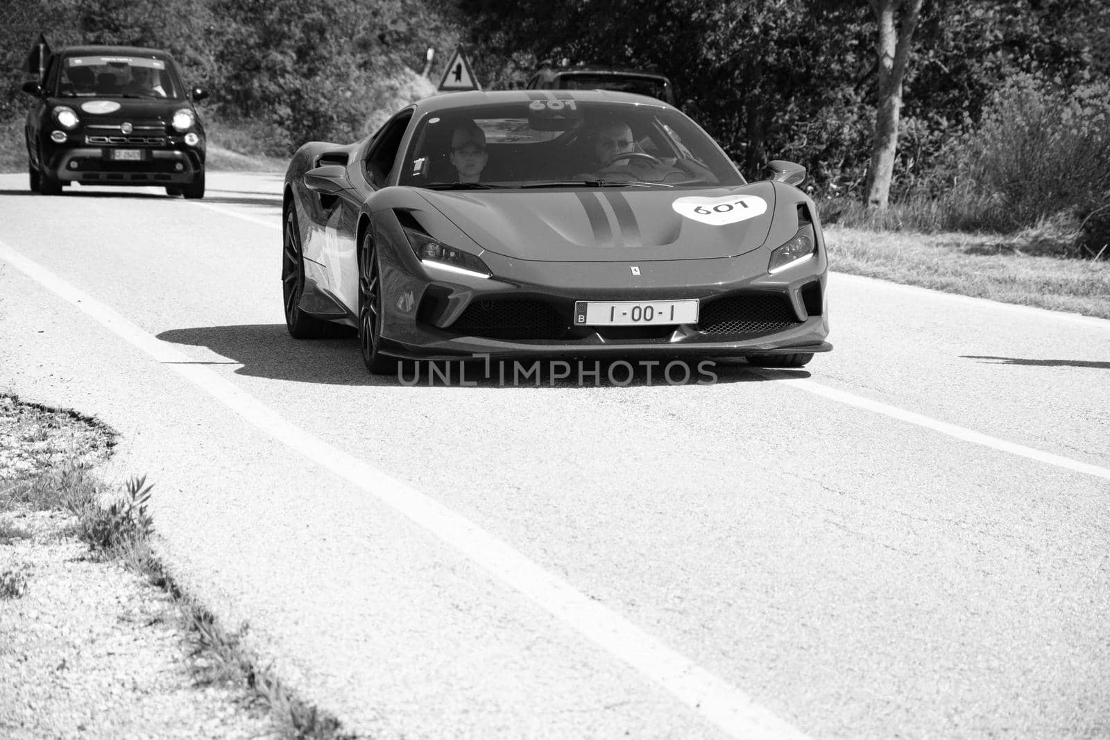 URBINO, ITALY - JUN 16 - 2022 : FERRARI TRIBUTE Ferrari F8 Tributo IN an old racing car in rally Mille Miglia 2022