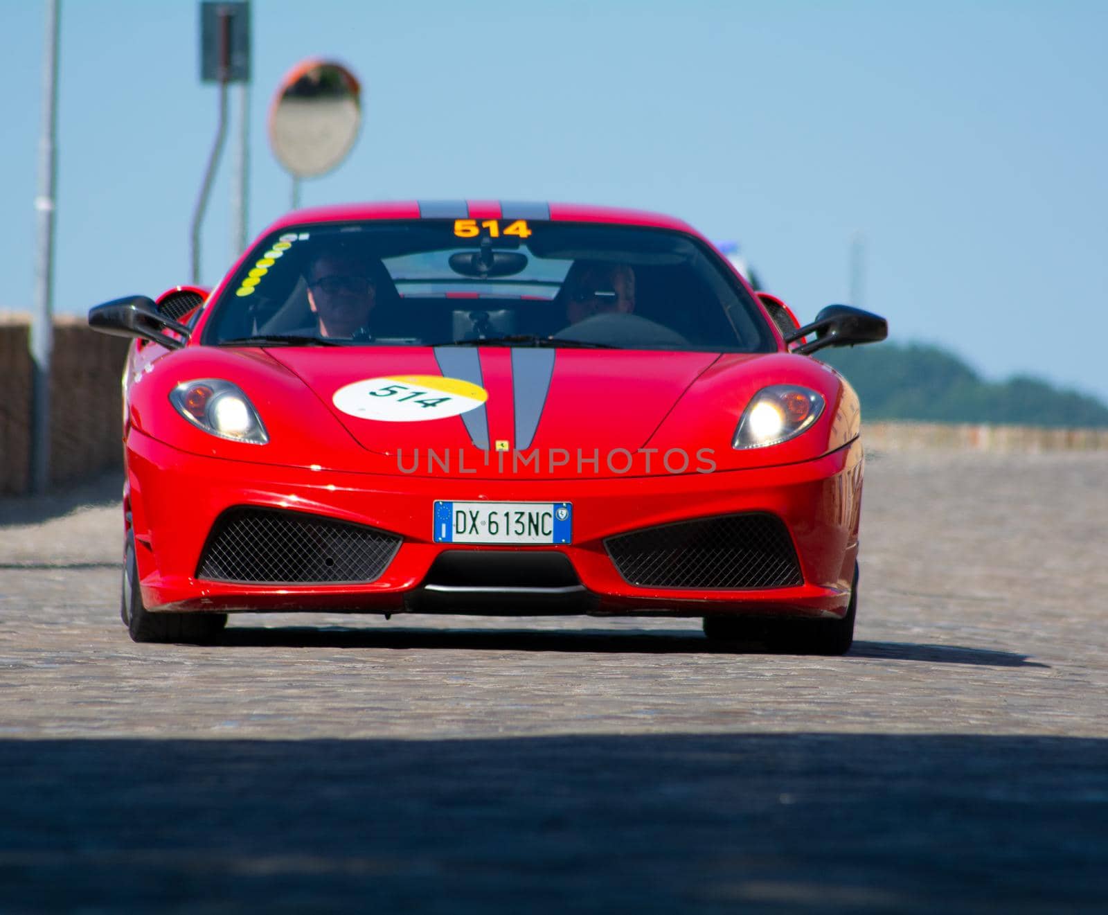 URBINO, ITALY - JUN 16 - 2022 : FERRARI TRIBUTE Ferrari F430 Scuderia IN an old racing car in rally Mille Miglia 2022