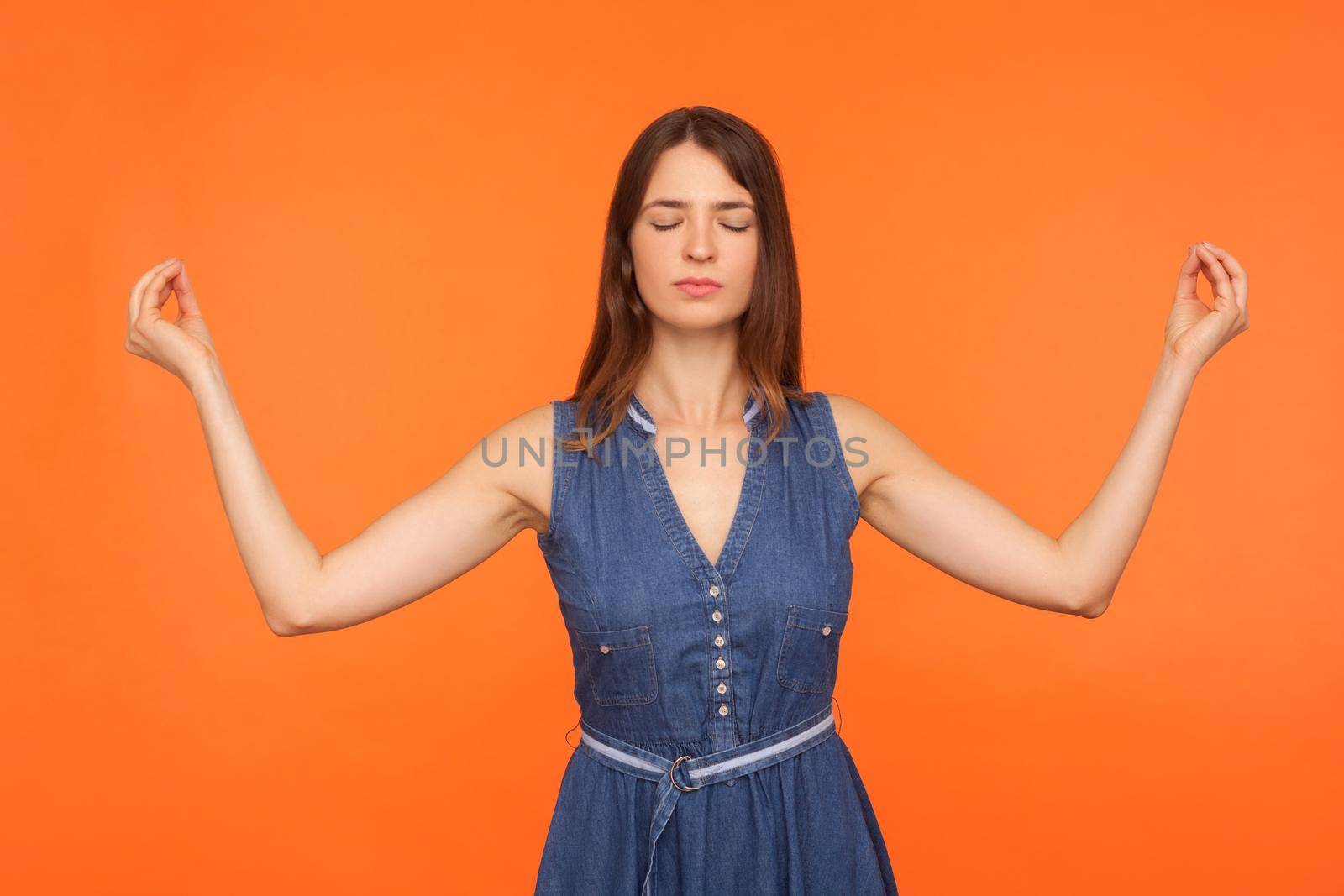 Portrait of young emotional woman on orange background. by Khosro1