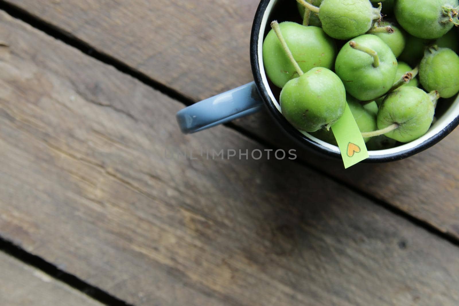 Food background. Healthy vegan food concept. Green apples in a cup.