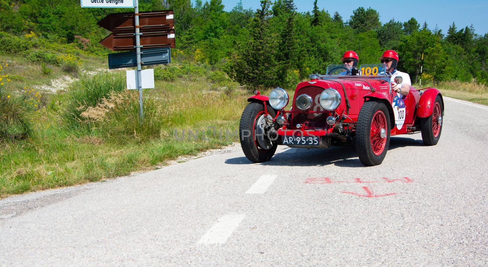 URBINO, ITALY - JUN 16 - 2022 : ASTON MARTIN 2 LITRE SPEED MODEL 1937 on an old racing car in rally Mille Miglia 2022 the famous italian historical race (1927-1957 by massimocampanari