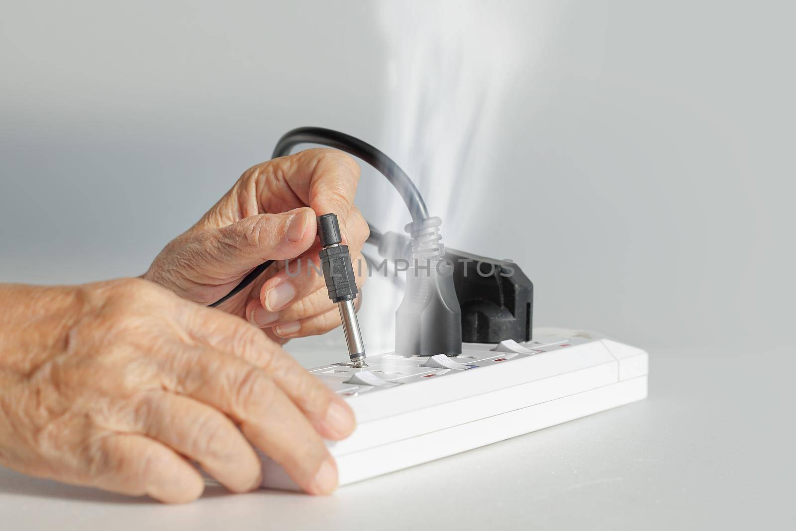 Elderly have a problem mistake plugging socket type to electrical outlet.