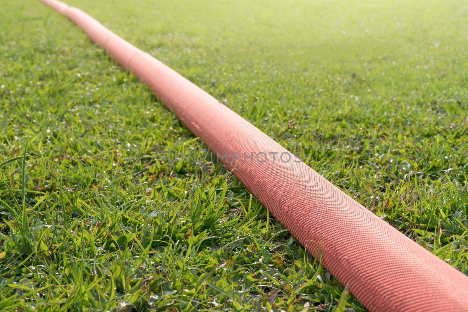 industrial hose in lawn of sport field. by toa55