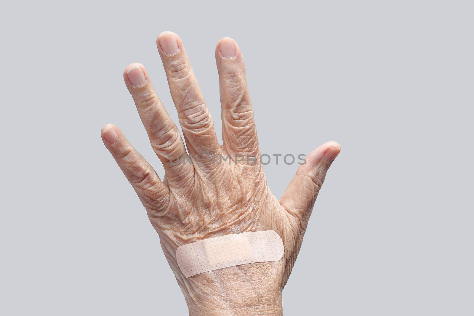 Elderly woman adhesive bandage on her hand
