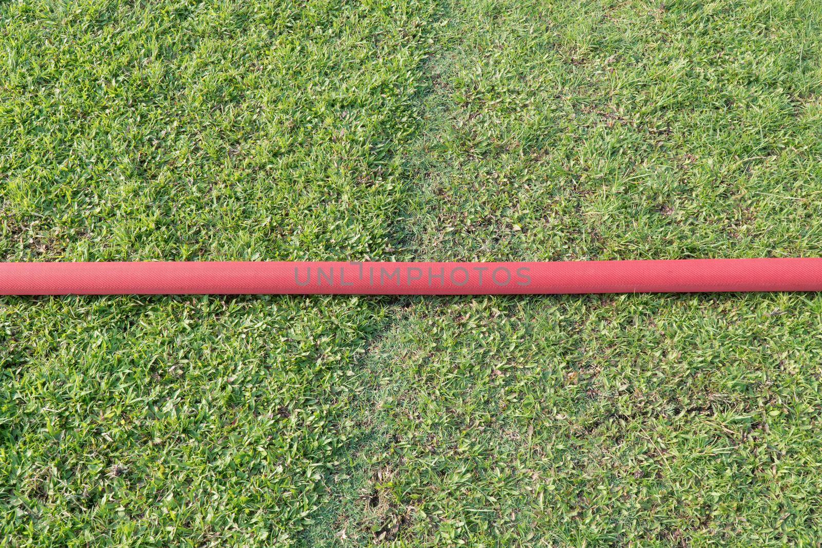 industrial hose in lawn of sport field. by toa55