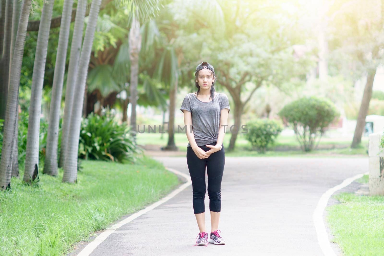 Running asian woman exercising in park. by toa55