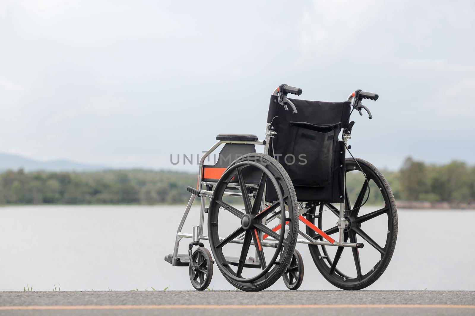 Empty wheelchair on lake