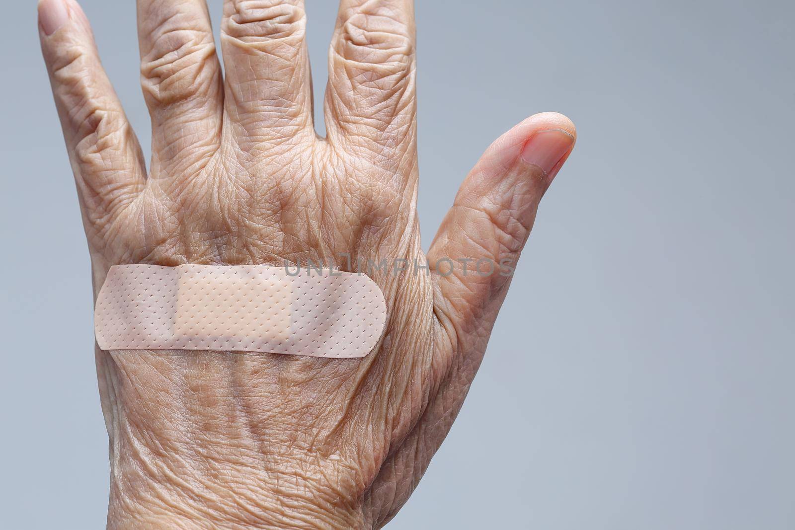 Elderly woman adhesive bandage on her hand by toa55