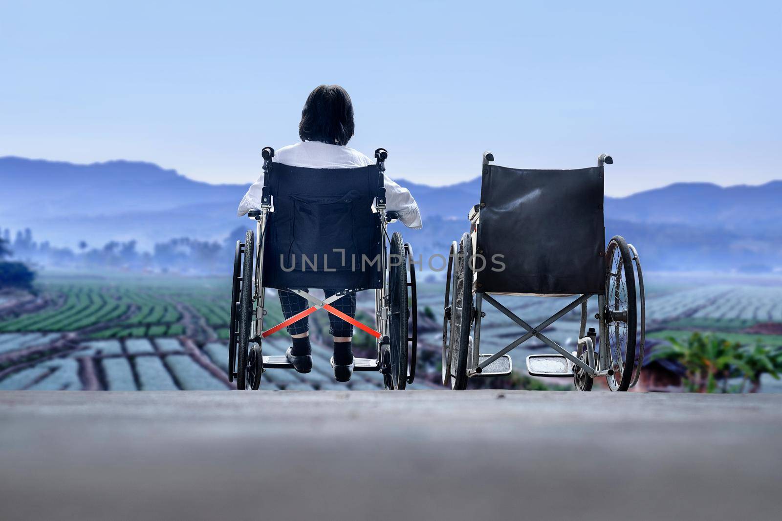 Elderly woman with empty wheelchair standing together by toa55