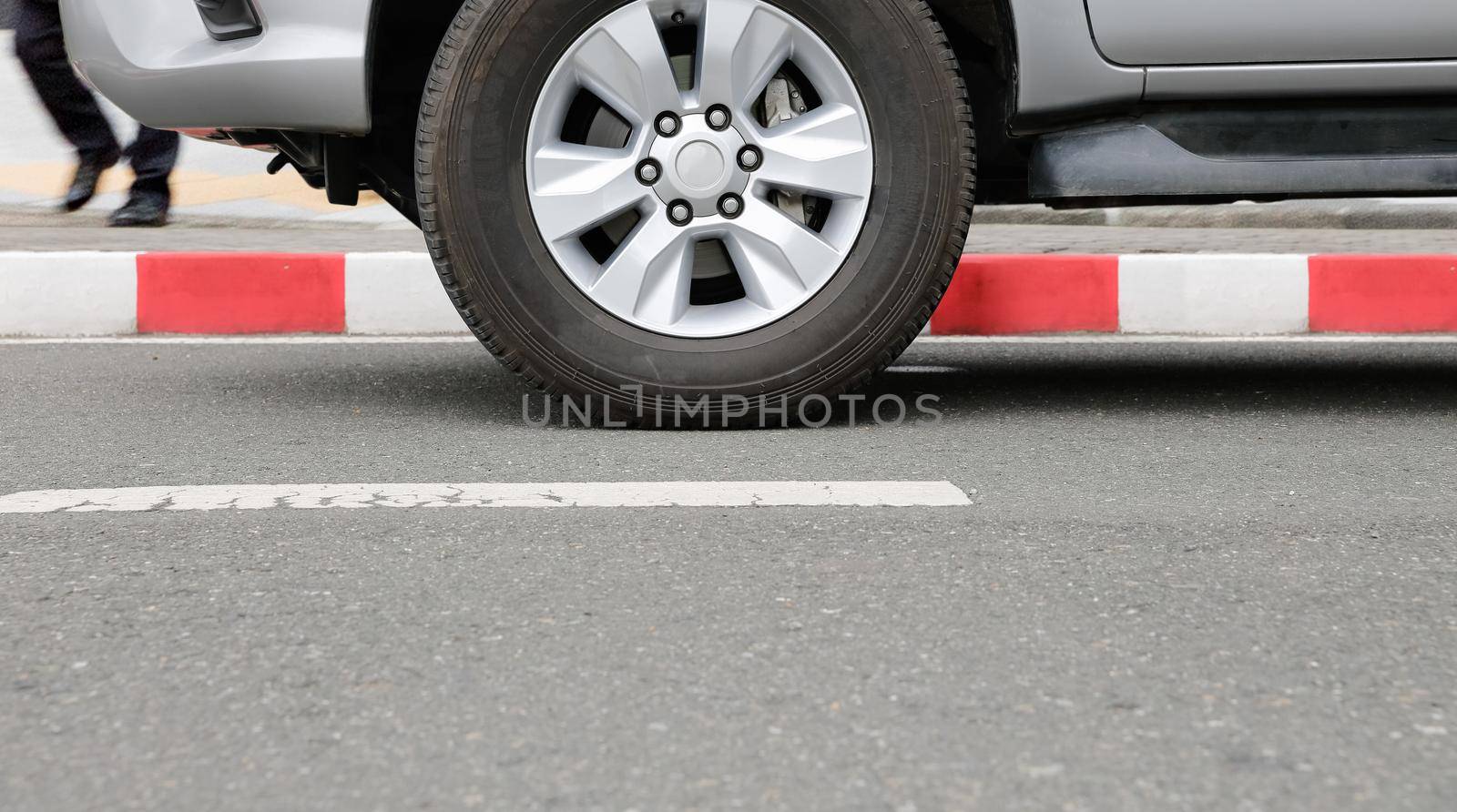 illegally parked car on red curb