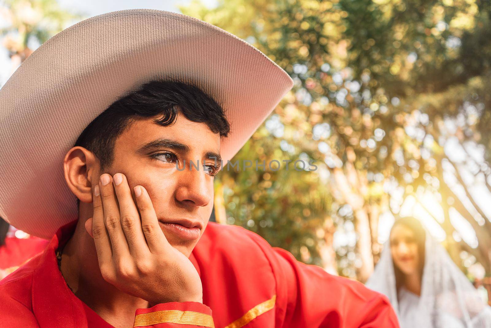 Latino teenager in love wearing traditional latinamerican clothes and hat outdoors in a park in Jinotega Nicaragua